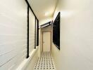 Long white hallway with patterned floor tiles