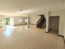 Spacious and well-lit living room with stairs