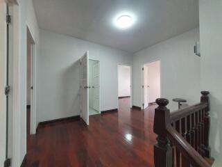 Hallway with doors and wooden flooring