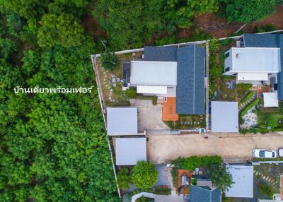 aerial view of residential buildings surrounded by greenery