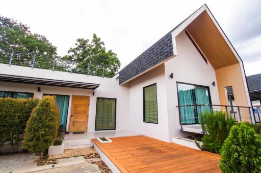 Modern house with wooden deck and large windows