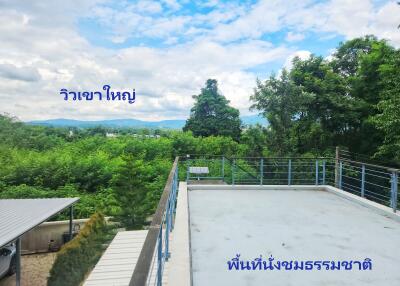 Rooftop terrace with natural seating area and large mountain view