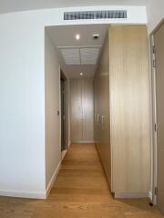 Bright modern hallway with wooden flooring and built-in storage