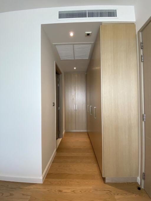 Bright modern hallway with wooden flooring and built-in storage