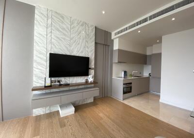 Modern living area with TV and open kitchen