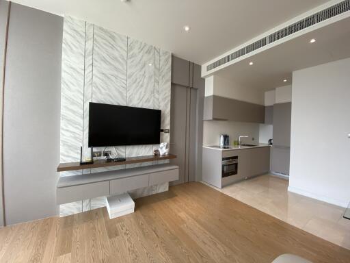 Modern living area with TV and open kitchen