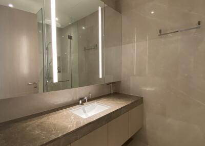 Modern bathroom with large mirror and marble countertop
