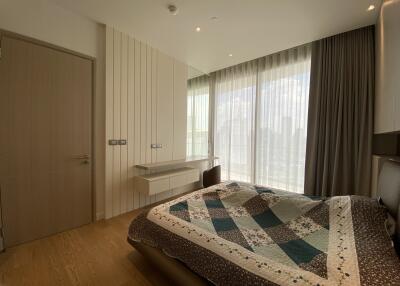 Modern bedroom with large windows and natural light