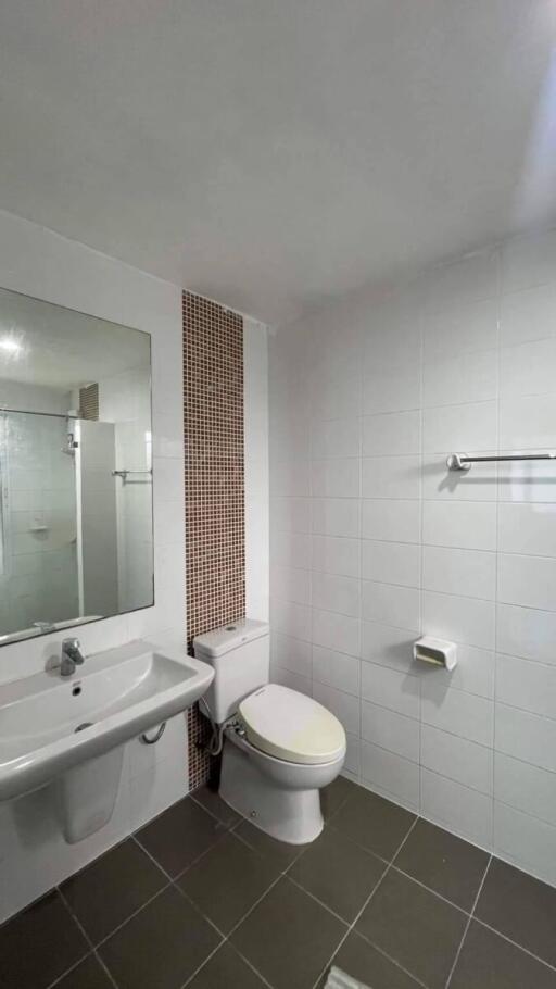 Modern bathroom with white tiles and porcelain fixtures