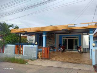 Front view of a residential property with a covered parking area.