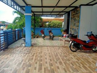 covered outdoor area with motorbikes and seating