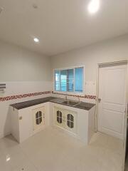 Simple kitchen with white cabinets and countertops