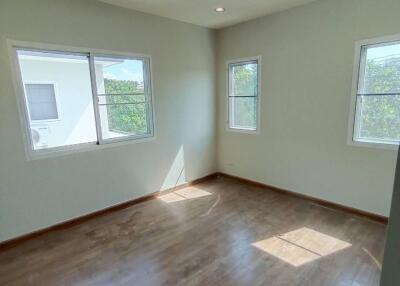 Bright bedroom with wooden flooring