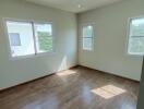 Bright bedroom with wooden flooring