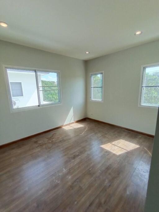 Bright bedroom with wooden flooring