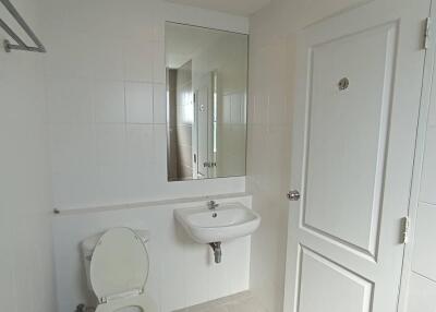 Bathroom with mirror, sink, and toilet