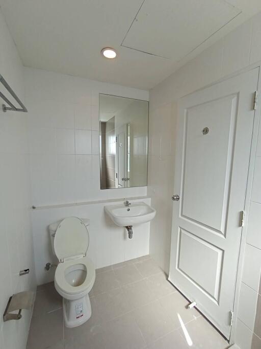 Bathroom with mirror, sink, and toilet