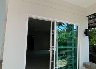 Glass sliding door leading into a modern home