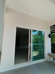 Glass sliding door leading into a modern home