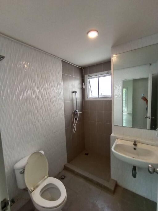 Bathroom with shower area, toilet, and sink