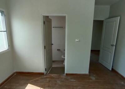 Empty bedroom with hardwood floor and en-suite bathroom