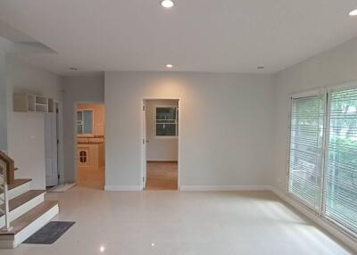 Spacious living room with large windows and recessed lighting