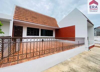 Photo of a building with a tiled roof and terrace