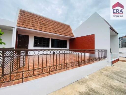 Photo of a building with a tiled roof and terrace