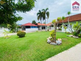 Front yard with green lawn and trees