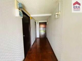 Long hallway with wood flooring