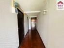 Long hallway with wood flooring