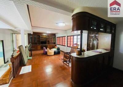 Spacious living room with wooden flooring and built-in cabinets