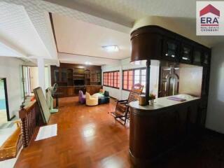 Spacious living room with wooden flooring and built-in cabinets