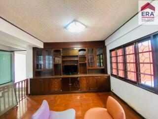 Living room with built-in wooden shelves and window with a view