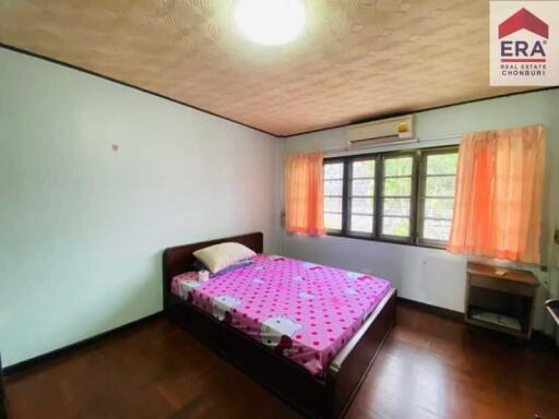 Bedroom with double bed and pink polka dot bedspread