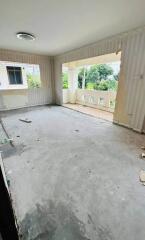 Unfinished living room with large window and balcony view