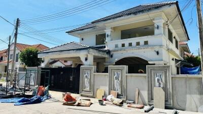 Two-story house with a gated entrance