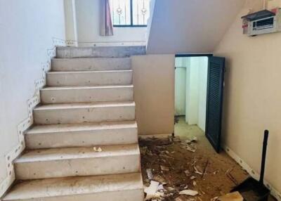 Staircase leading to upper floor with visible wear and tear