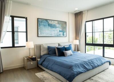 well-lit bedroom with a large window and modern decor