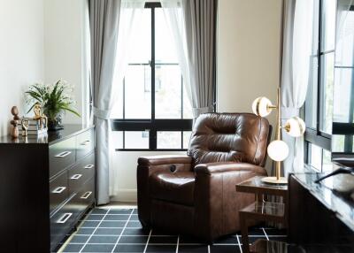 Cozy living room with armchair and large windows