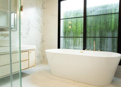 Modern bathroom with a standalone bathtub and large window