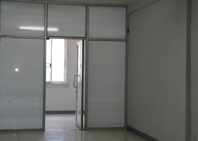 Empty room with tiled floor and partition walls