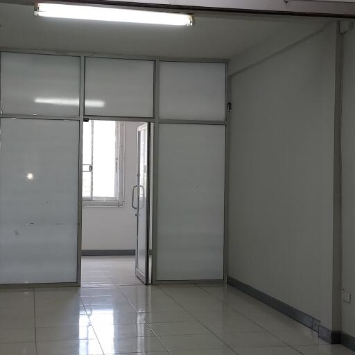 Empty room with tiled floor and partition walls