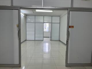 Spacious office room with sliding doors and windows.