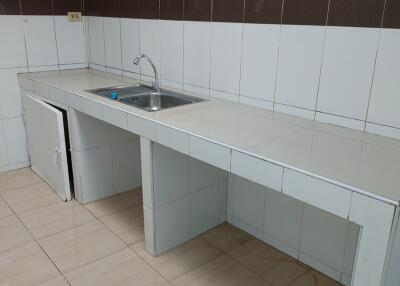 Simple kitchen with white tile countertops and backsplash