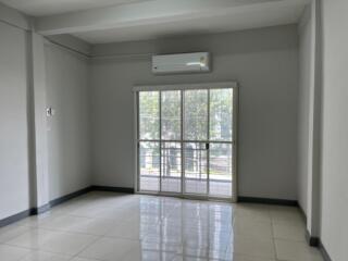 Spacious living room with large window and air conditioning