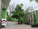 Spacious outdoor area in the property with potted plants and trees.