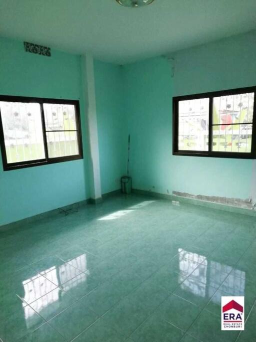 Empty bedroom with green walls and tiled floor