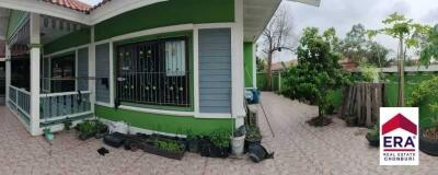 Exterior view of a house with a garden and pathway