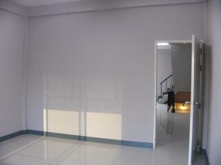 Empty room with gray walls and open door